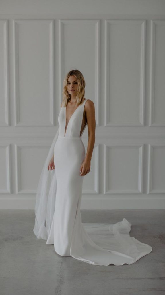 Bride comparing an online wedding dress order to an in-person bridal fitting