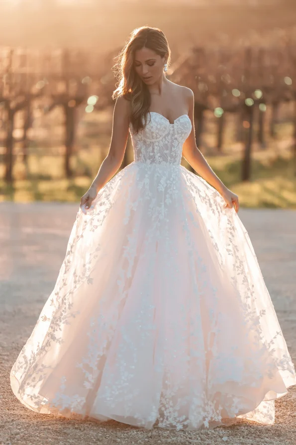 A sense of elegance surrounds a woman wearing the A1252 by Allure, a stunning white dress.