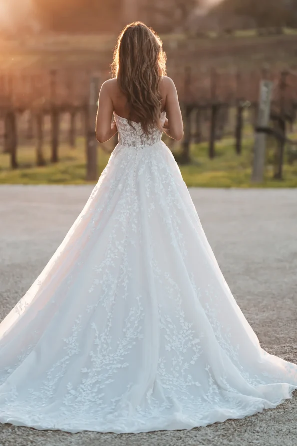 A bride wearing the A1252 by Allure gown exudes timeless elegance on her wedding day.