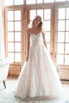 A sense of elegance surrounds a woman wearing the A1252 by Allure, a stunning white dress.