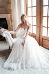 A sense of elegance surrounds a woman wearing the A1252 by Allure, a stunning white dress.