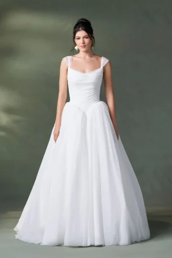 The A1500 by Allure is a white A-line wedding dress featuring a ruched bodice, sweetheart neckline, and tulle skirt.