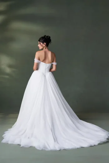 The A1500 by Allure is a white, strapless, floor-length bridal gown with an off-the-shoulder neckline and a button-down back.