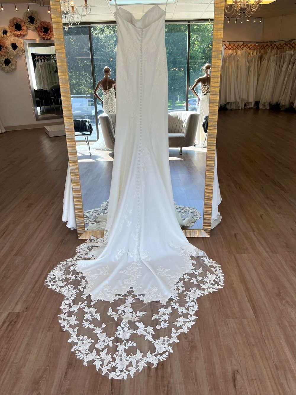 A crepe and lace wedding dress by Enzoani at Flares Bridal + Formal