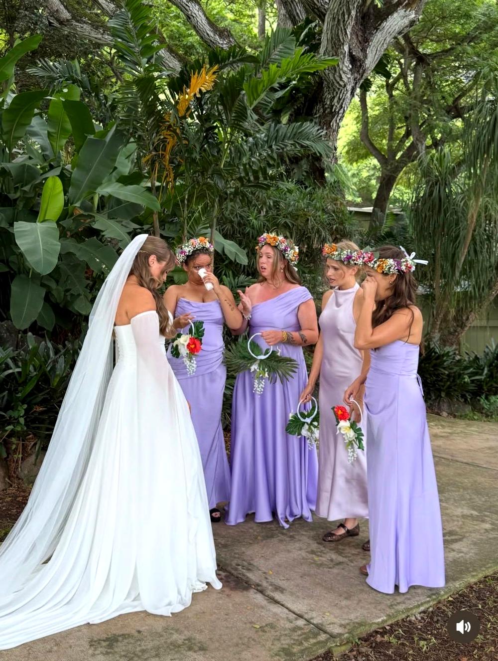 A bride in a sheath wedding dress with a cathedral veil