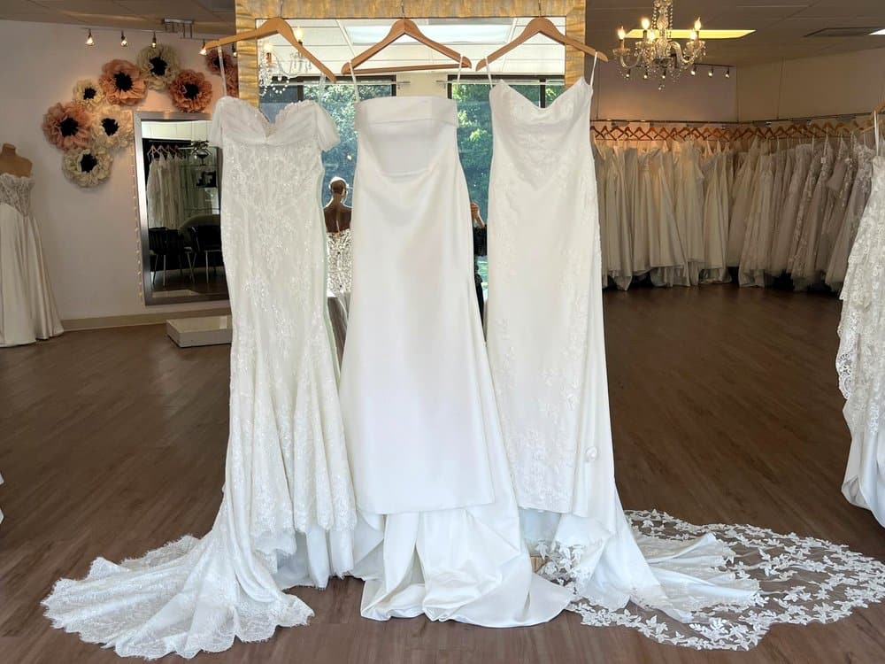 Three fitted wedding dresses in full lace, mikado, and crepe with lace, at Flares Bridal + Formal