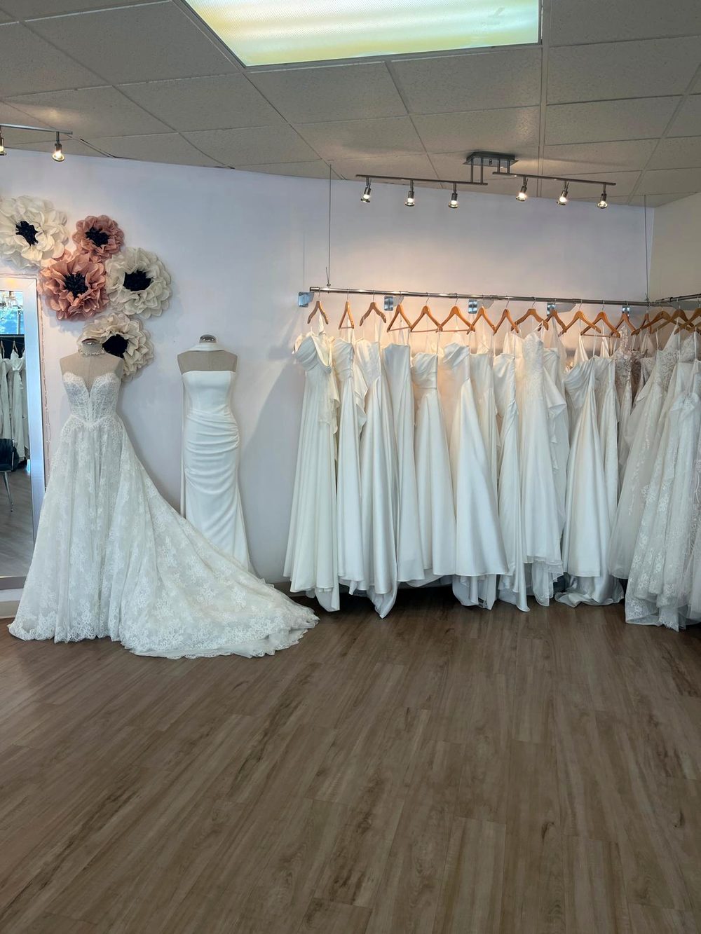 Wedding dresses on the rail at Flares Bridal + Formal in Walnut Creek, showing the range of price tiers